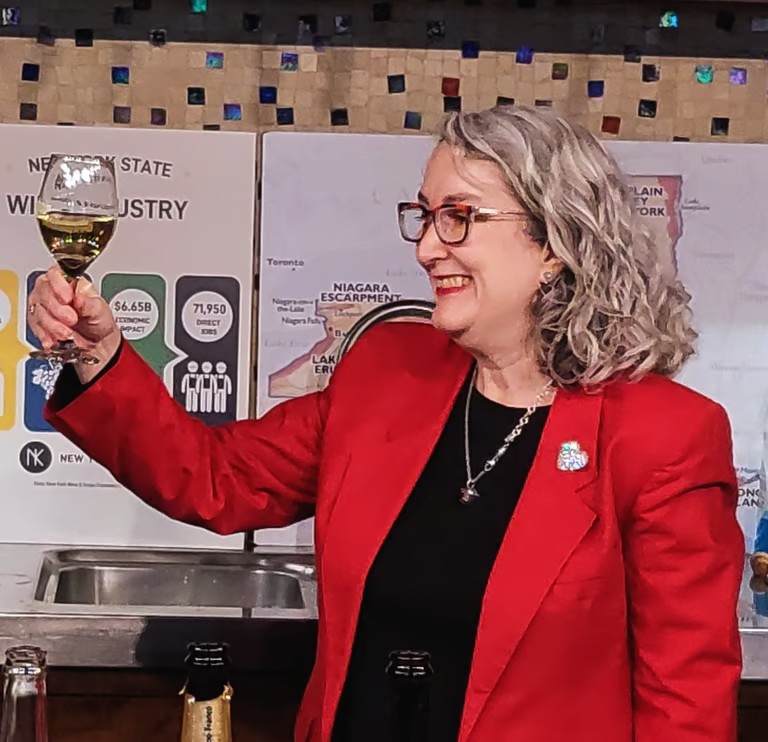 Heather McKechney raising a glass during a presentation